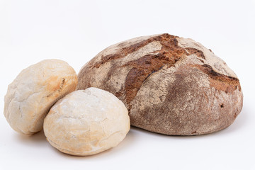 Fototapeta na wymiar Delicious freshly rye dark bread and two white bread pieces on White background