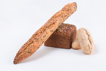 Assortment of delicious baked bread on white background