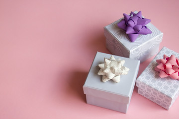 Gift boxes on pink background.
