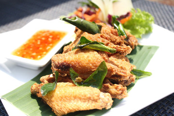 Deep fried chicken wring with herb put on white dish.