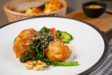 Catfish croquettes with baby broccoli, cauliflower, sweet pepper and withe wine sauce