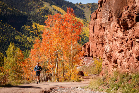 Telluride, Colorado, USA: A male trailrunner running on trails around Telluride on a cool but sunny autumn day.