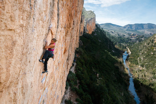 Woman climbing on rock