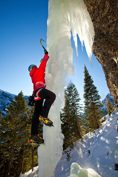 A Man Climbs A Malnourished Bingo World (WI6+) In The Bingo Cave During A Beautiful Day At Hyalite Canyon In Montana.