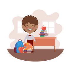 student boy with school supplies in the classroom