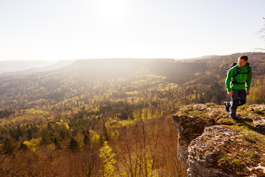 Albstatt-Onstmettingen, Baden-W&cedil;rttemberg, Germany: A male hiker on the "Hangender Stein" cliff along the "Traufgang Zollernburg-Panorama" trail.