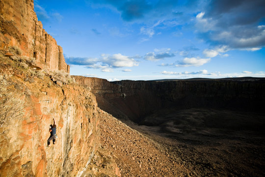 A man leads a 5.10c climb at Vantage in Washington at sunset.       