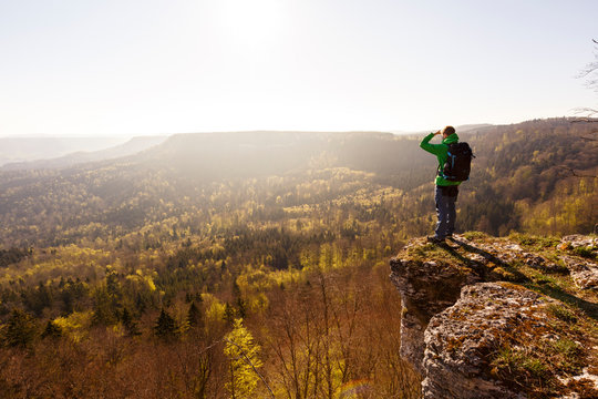 Albstatt-Onstmettingen, Baden-W&cedil;rttemberg, Germany: A male hiker on the "Hangender Stein" cliff along the "Traufgang Zollernburg-Panorama" trail.