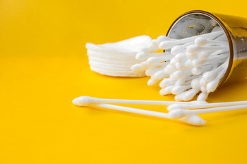 cotton buds and makeup Cleaning Discs  on a yellow background with copy space