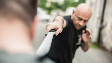 Eskrima and kapap instructor demonstrates machete weapon fighting technique