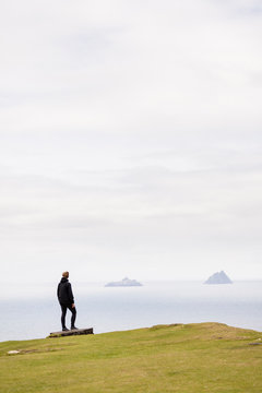 Bray Head, Bray, Kerry, Ireland: A woman enjoying the view towards the Skellig Islands.