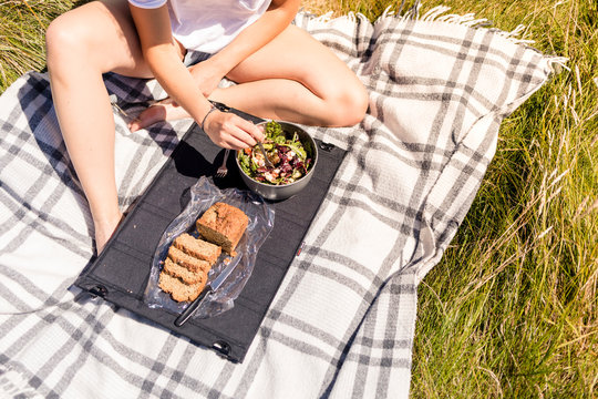Barley Cove Beach, Dough, Cork, Ireland: A woman enjoying a picnic in the sun.
