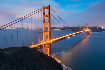 Classic panoramic view of famous Golden Gate Bridge in beautiful evening light on a dusk with blue sky and clouds in summer or autumn, San Francisco, California, USA