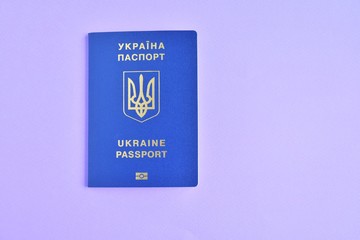 Biomedical Ukraine id passport on purple  background with selective focus and empty space for photo or text. Ukrainian id passport with a golden symbol trident on blue backdrop. Copy space 