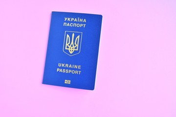 Two Biomedical Ukraine id passports on magenta background with selective focus and empty space for photo or text. Ukrainian id passport with a golden symbol trident on neon backdrop. Copy space 
