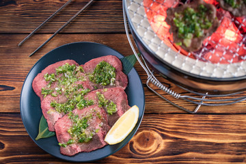 japanese barbeque beef tongue with green onion on charcoal grill