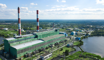 Industrial plant on the background of the lake.Thermal power plant and electricity. Technology and...