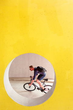 Stuttgart, Baden-W&cedil;rttemberg, Germany: Male cyclist Jens Kraft on his fixed gear bike in the parking garage at the Stuttgart Airport.