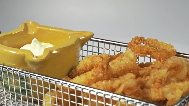 Rings of calamari whit white sauce mayonnaise whit ginger - calamares fritos tipical spanish street food - squid whit white screen , fried recipe