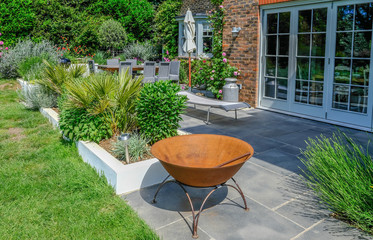 Modern contemporary patio in an English country garden.
