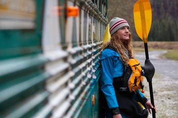 A female kayaker with a drysuit and full boating gear at the Three River Motel along the Lochsa River in Idaho.
