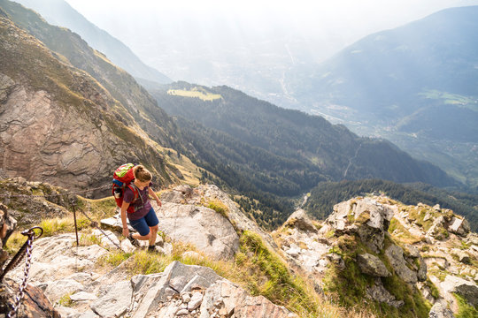 Spronser Lakes Hike, South Tyrol, Italy: A female hiker at the Hochgangscharte.