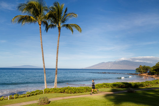 Maui, Hawaii, USA: Male runner on the Wailea Beach Path leading across the different resorts with a scenic view over the ocean.
