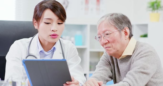 Female doctor console elder patient