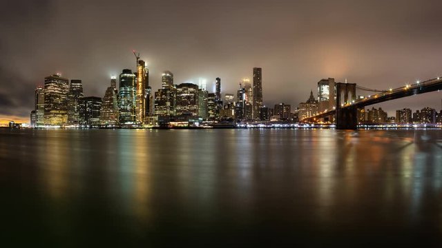 Cinemagraph of a Panoramic view of the Downtown Manhattan and Brooklyn Bridge during a foggy night. Taken in New York, NY, United States. Still Image Continuous Animation