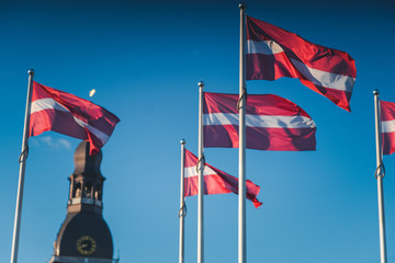 Latvian flags against the background of the Dome Cathedral in the center of the old city of Riga, Latvia, the Baltic countries