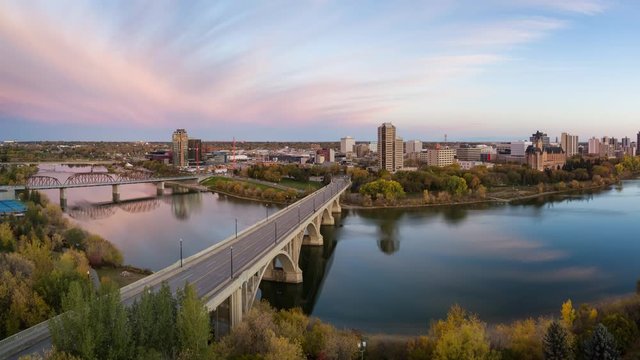 Aerial view of a bridge going over Saskatchewan River during a vibrant sunrise in the Fall Season. Taken in Saskatoon, SK, Canada. Still Image Continuous Animation