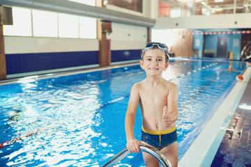 Little boy smiling child smiling at swimming pool. © Studio Romantic