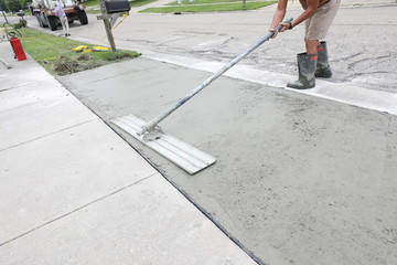 concrete work is being performed at a home in a urban neighborhood
