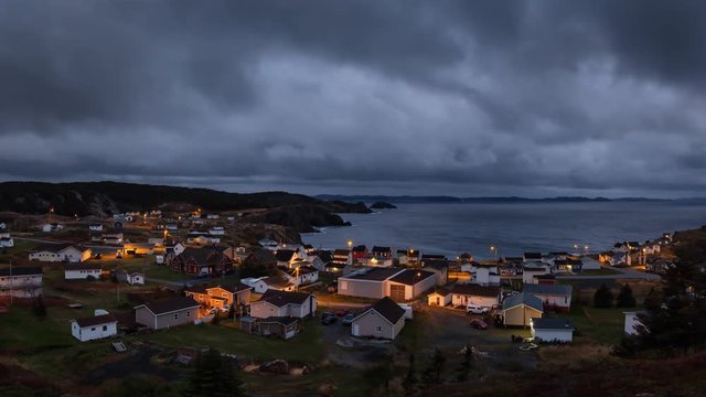 Panoramic view of a small town on the Atlantic Ocean Coast during a dark cloudy sunset. Taken in Crow Head, North Twillingate Island, Newfoundland and Labrador, Canada. Still Image Animation