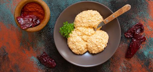 Serbian salad called Urnebes of cheese and chili peppers, paprika powder, chopped peppers and dry peppers (aleva). Traditional Serbian appetizer. Serbian cuisine