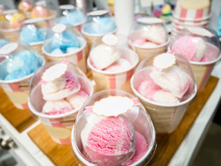 Ice cream in cups on counter, Strawberry and Mint flavors. Popular cold summer refreshing ice cream dessert. Selective focus mockup