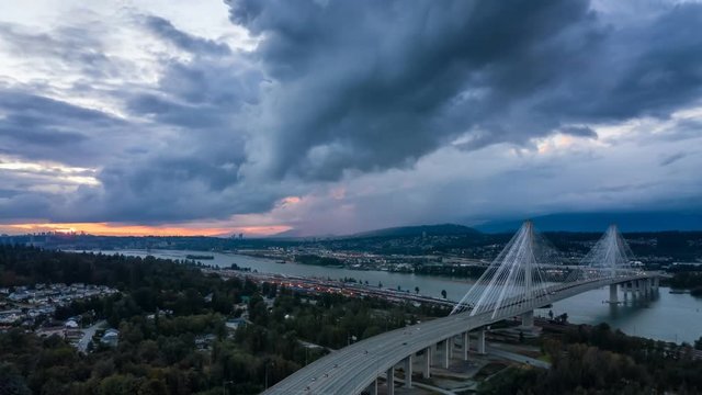 Aerial view of Trans Canada Highway near the Port Mann Bridge during a dramatic cloudy sunset. Taken in Surrey, Vancouver, BC, Canada. Still Image Continuous Animation