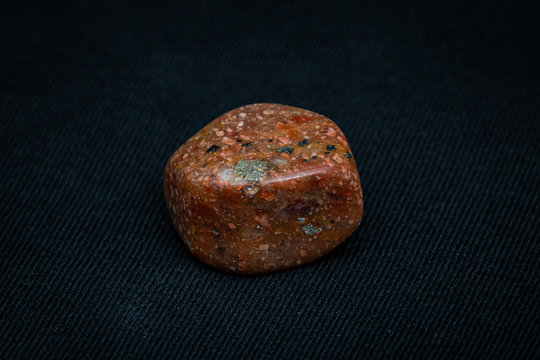 Unakit rare gemstone shiny polished in different tones of brown red and orange