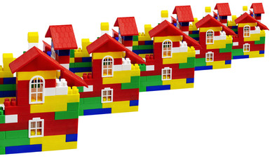 Multi-colored toy houses from plastic cubes on a white background. Place for text. Is isolated. Conceptual banner. Building Copy spase