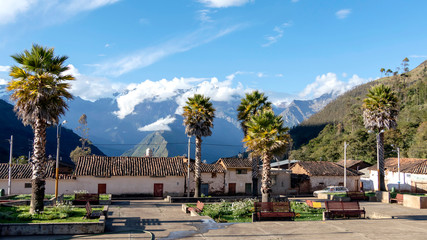 The main square of Cachora village with snow Andes mountains on the background, Peru