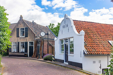 Fototapeta na wymiar Old houses along the Dorpstraat in the picturesque village Drimmelen, Netherlands