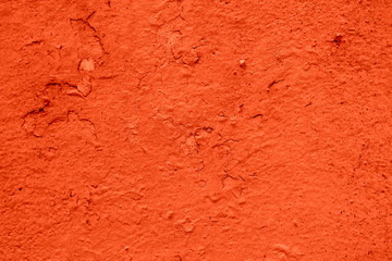 Fototapeta premium Dirty orange stucco wall with irregularities