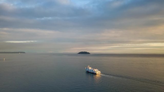 Aerial view of a ferry boat in the ocean during a vibrant cloudy sunset. Taken in Horseshoe Bay, West Vancouver, British Columbia, Canada. Still Image Continuous Animation