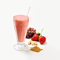 Glass with tasty grape and strawberry smoothie on white background, with ingredients aside on white background