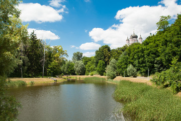 Fototapeta na wymiar Feofania is the youngest garden in Kiev, an excellent example of landscape architecture. Pond in summer sunny day