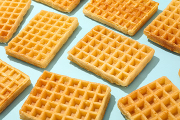 Flat lay composition with belgian waffles on color background