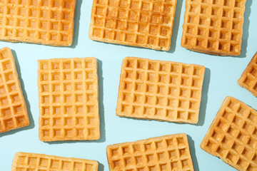 Flat lay composition with belgian waffles on color background