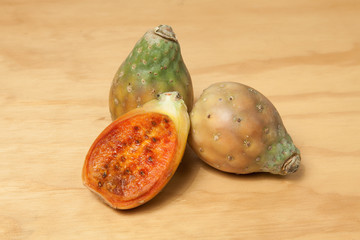Prickly pear cactus fruits - Opuntia ficus indica; photo on wooden background