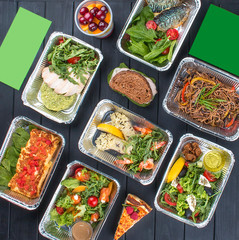 A set of diet dishes in containers on a dark wooden background. Takeaway. Diet and healthy food.