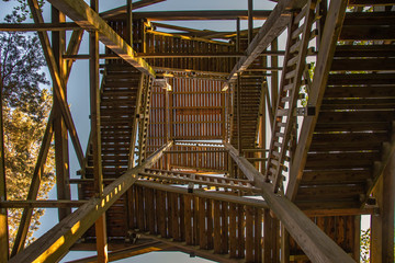 View from below into the inward of a wooden lookout tower.